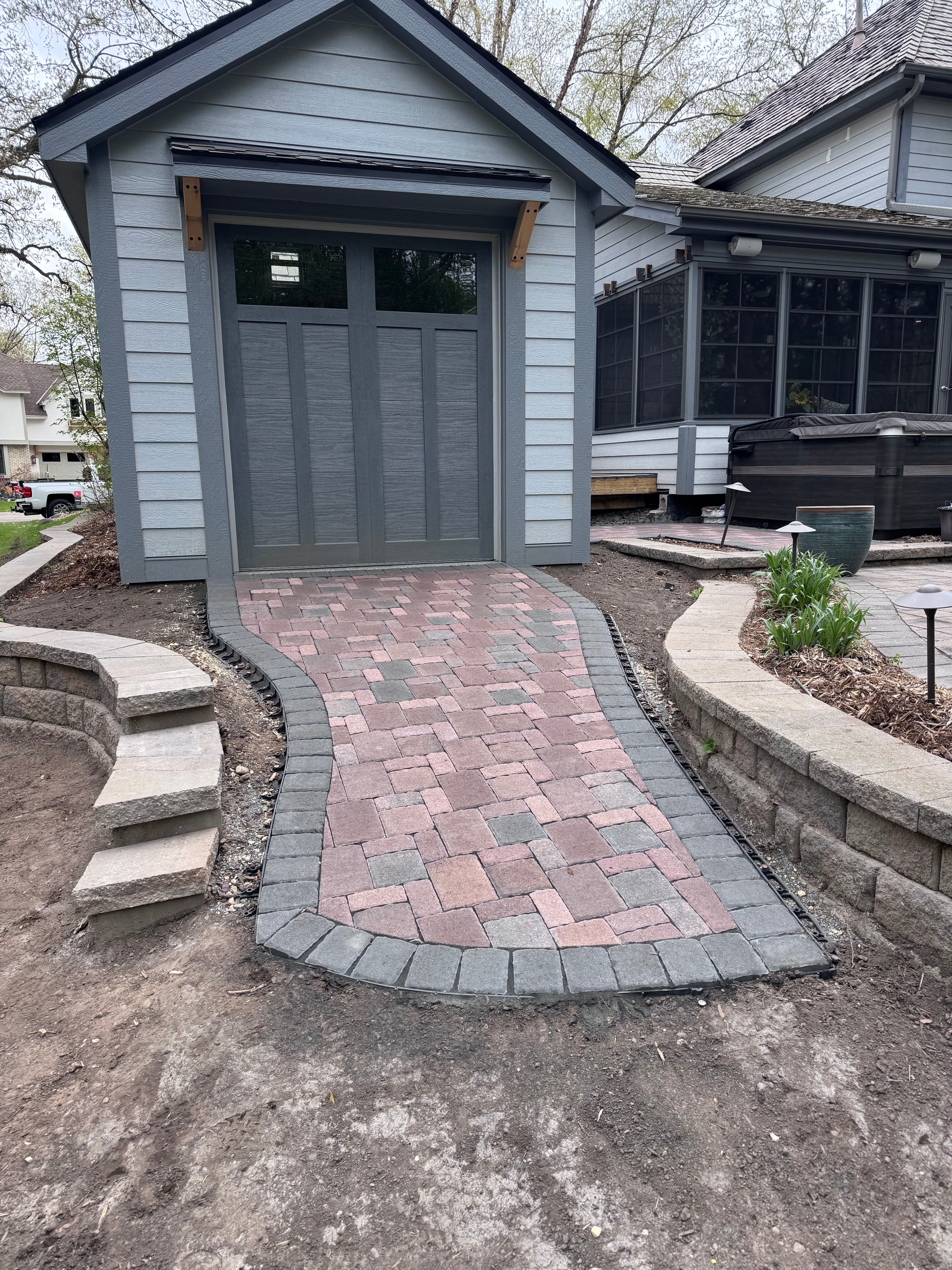 Project Paver Walkway and Retaining Wall Install Around a Backyard Shed image
