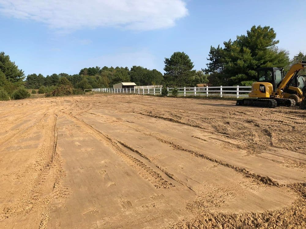 Cleared landscape with heavy machinery, preparing land for construction or landscaping project.